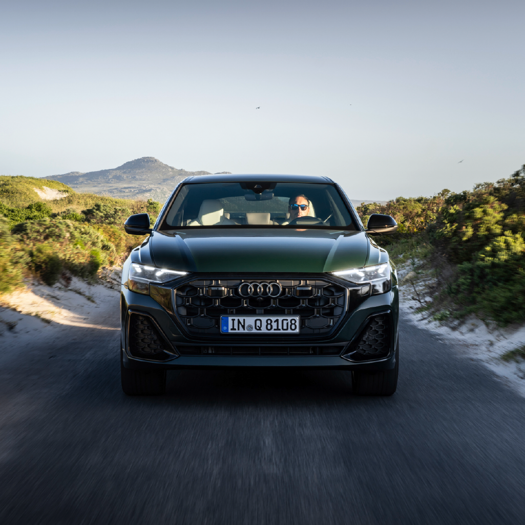 Front profile view of an Audi Q7 accelerating.